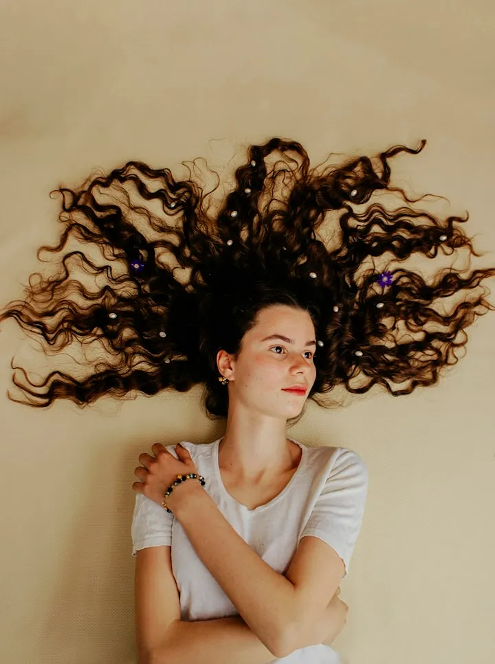 Woman with curls against soft background