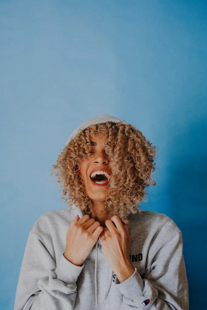 Portrait of curly-haired woman with golden earrings